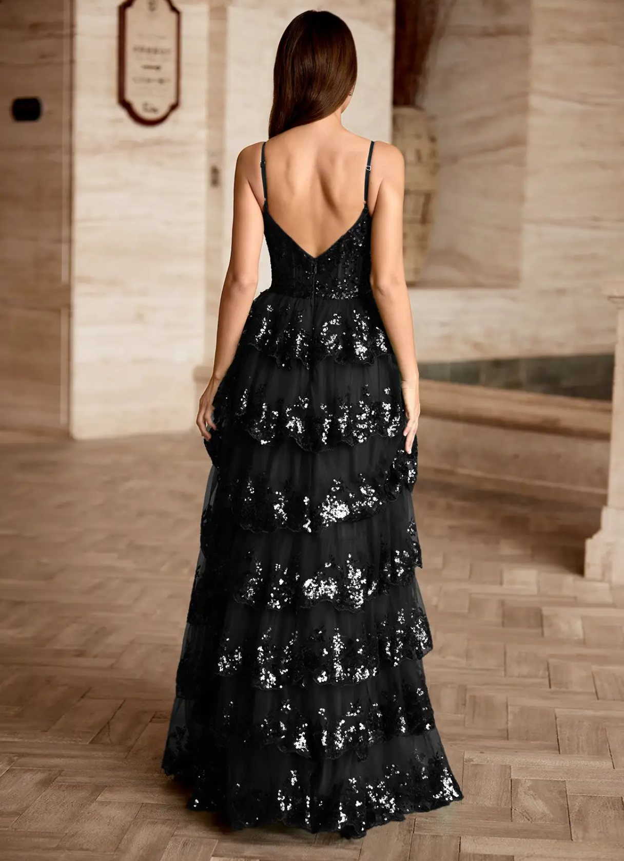 Back view of black sequin tiered ruffle prom gown with V-back design, spaghetti straps, back zipper closure, and floor-length formal skirt by VEDRESS
